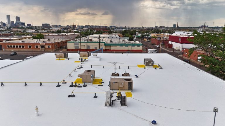 Aerial view of commercial roof coated by JJ Roof Coatings.