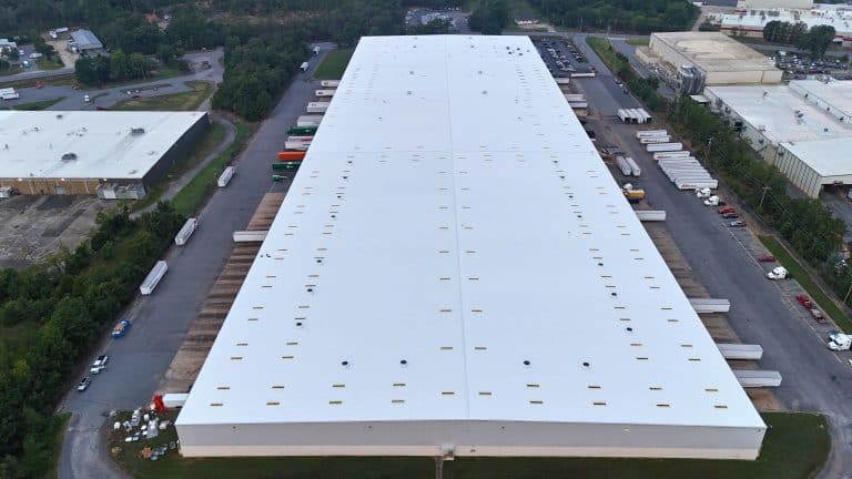 Drone image of metal roof coated with reflective roof coating.