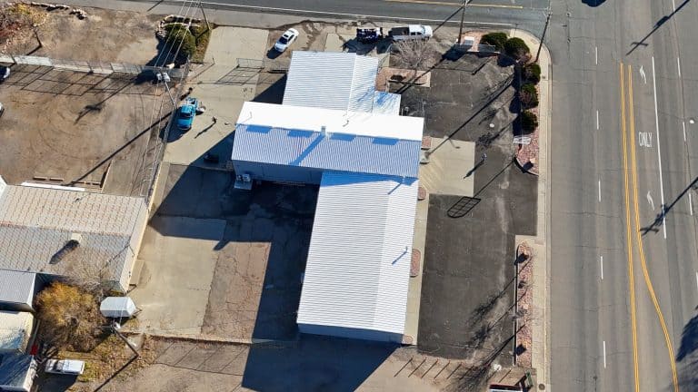 Drone view of large commercial roof with fresh coating.